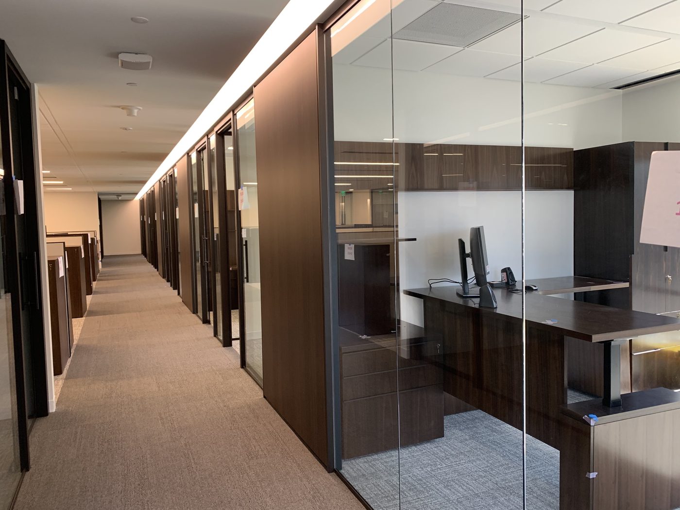 Wood-framed glass private offices, finished hallway